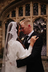 Back view of a Spanish-style bridal veil with hand-sewn lace appliqués