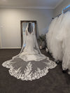 Back view of the bride wearing the ALLIE veil, highlighting the elegant lace and beadwork."