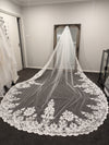 Bride lifting the blusher layer of the OLGA veil, emphasizing the soft tulle and lace details