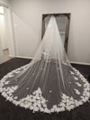 "Detailed shot of the handcrafted 3D flowers and Venice lace on the INEZ veil's edge."