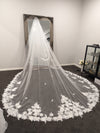 "Bride wearing the INEZ cathedral-length wedding veil, featuring 3D floral appliqués and Venice lace detailing."