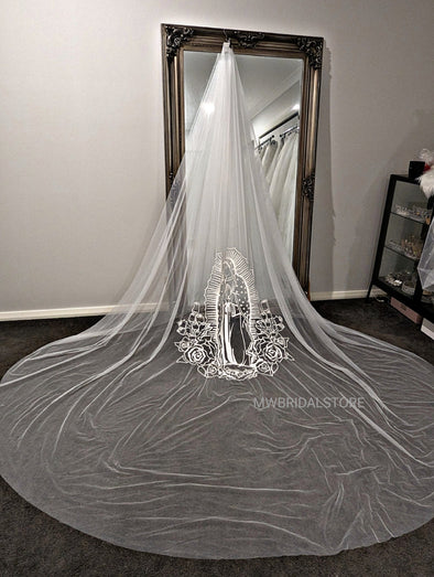 Intricate embroidery of Mother Mary gracing the wedding veil