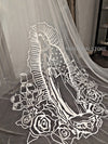 Elegant portrayal of Mother Mary in embroidered form, enhancing the wedding veil's beauty