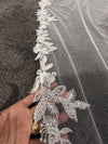 "Close-up of the ELIKA veil showcasing the delicate floral lace patterns and beadwork."