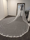 "Back view of a bride adorned with the ELIKA mantilla veil, displaying its flowing cathedral length."