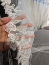 "Close-up of the ELIKA veil showcasing the delicate floral lace patterns and beadwork."