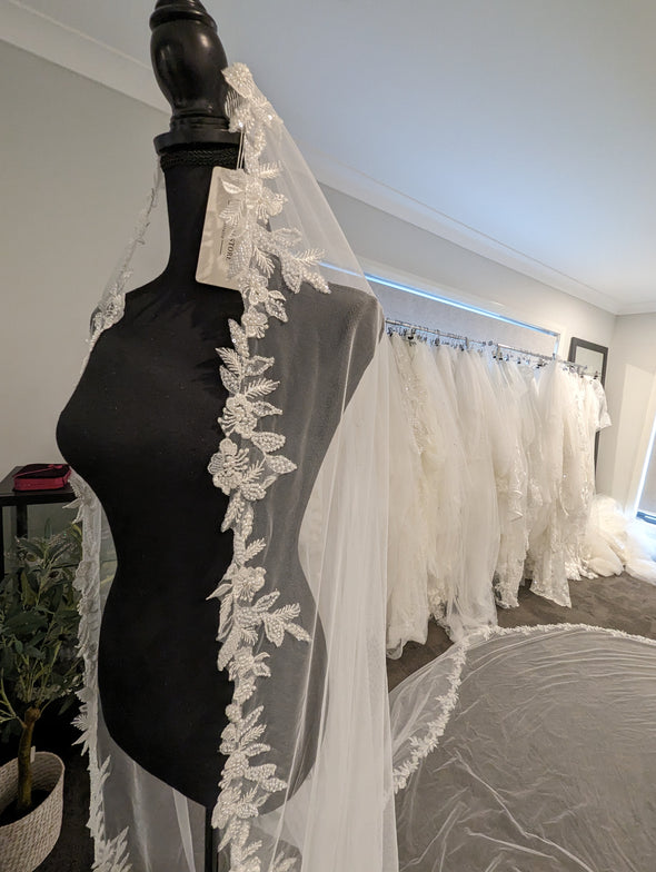 Close-up of the ELIKA veil showcasing the delicate floral lace patterns and beadwork."