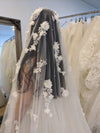 Bride holding the edges of the NADIA cathedral veil, showcasing its lightweight and airy design.
