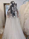 Bride standing outdoors with the NADIA 3D floral cathedral veil flowing behind, capturing its ethereal elegance.