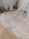 Detailed shot of 3D lace flower appliqués on wedding veil for a romantic bridal look