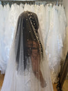 Image of a pearl wedding veil with delicate pearl accents