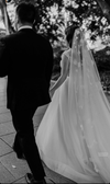 Back view of a bride in a wedding gown with the NADIA cathedral veil, featuring a cascading floral pattern.