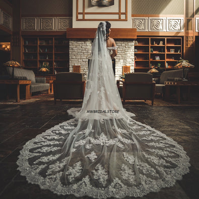 Close-up of REANNA Handmade Lace Mantilla Veil with intricate floral lace trim